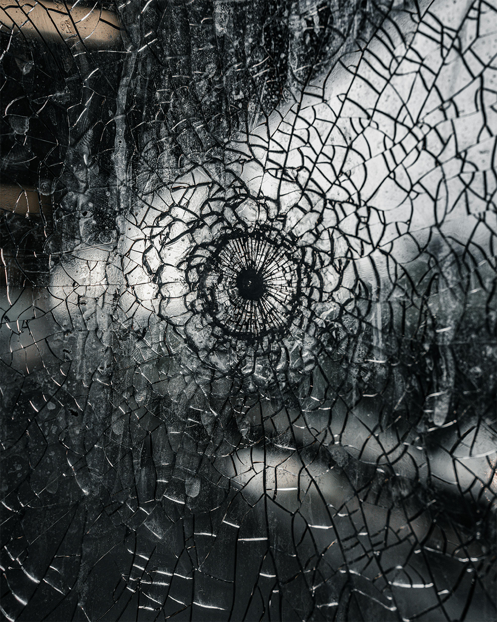 Shattered glass door showing impact damage that GlassLock security film helps prevent and contain