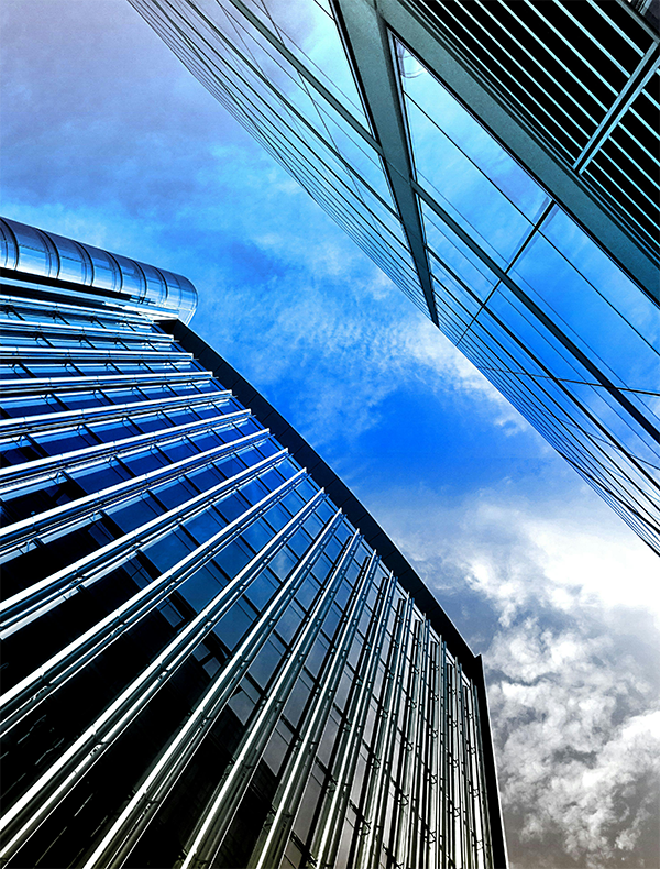 Glass skyscraper building showing RF signal leakage risk addressed by SpyGuard window film